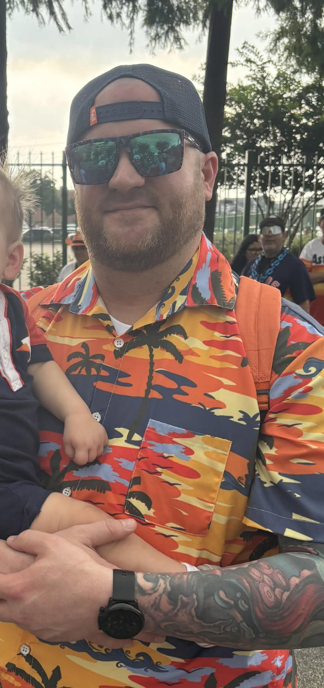 Will H wearing a colorful tropical-print shirt and sunglasses outdoors
